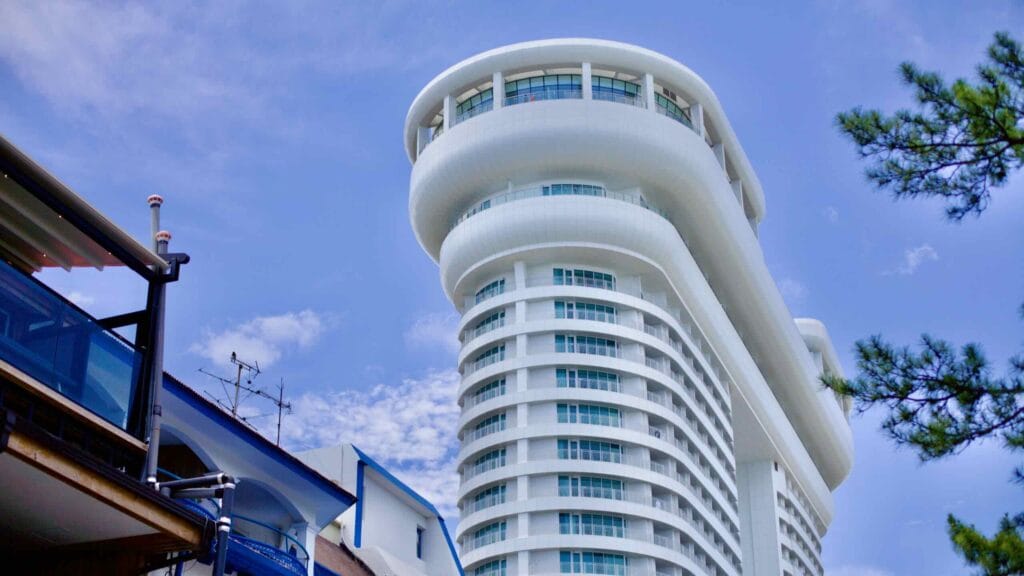 The striking Skybay Hotel Gyeongpo, a 20-story white structure against a blue sky, offers panoramic views of Gyeongpodae Beach and Lake.
