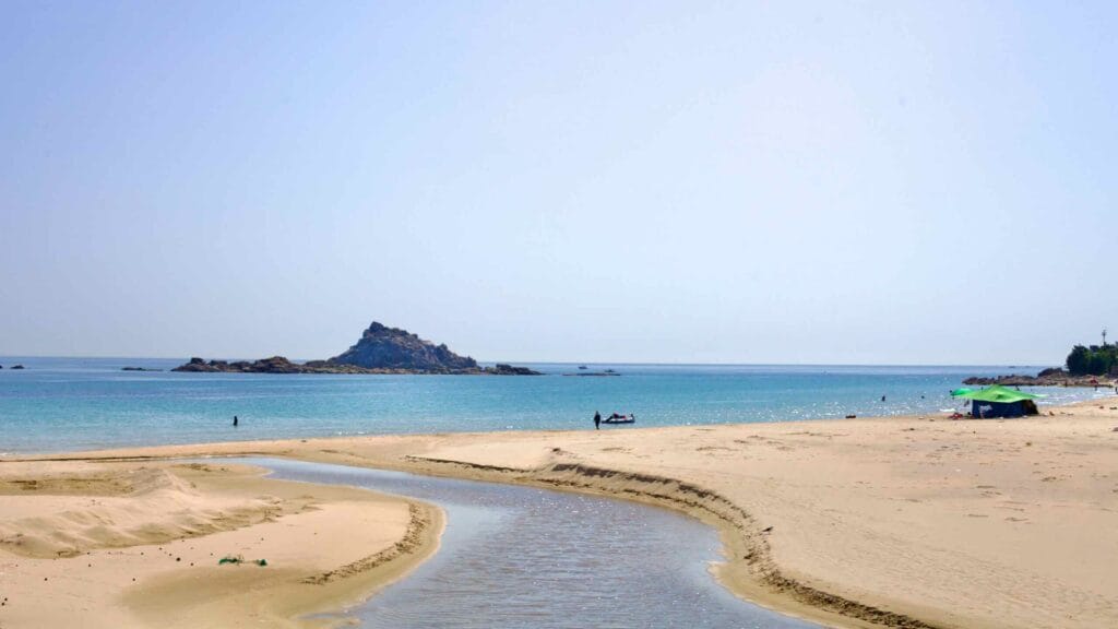 A stream cuts through the sandy shores of Sampo Beach, flowing into the East Sea.