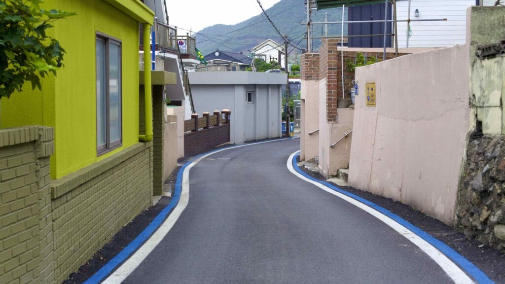 A narrow village road snaking through Bugyeong Port (부경항) in Yeongdeok County on Korea's east coast.