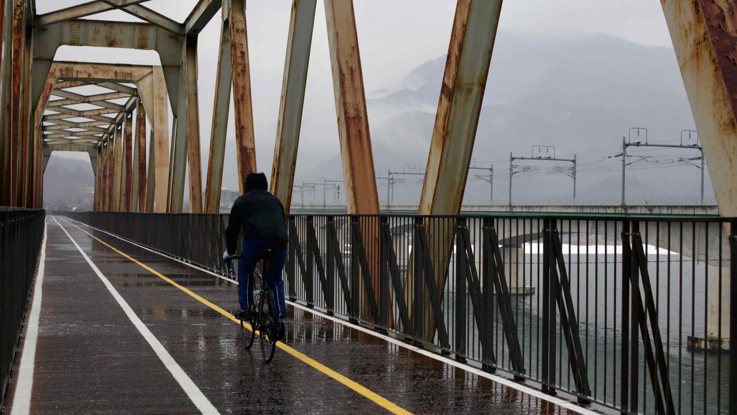 A picture of a bike rider on the Bukhangang Bridge outside of Seoul.