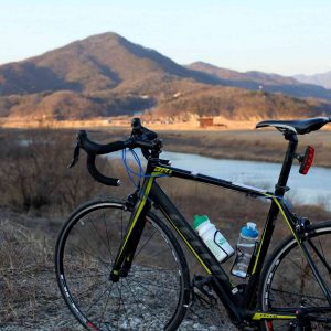 A bicycle sits near a hill along the Hangang Bicycle Path near the city of Yeoju.