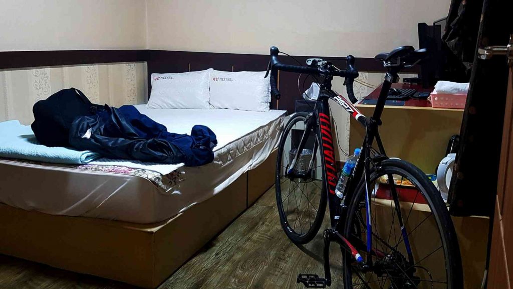 A picture of a bike inside a motel room in Korea.