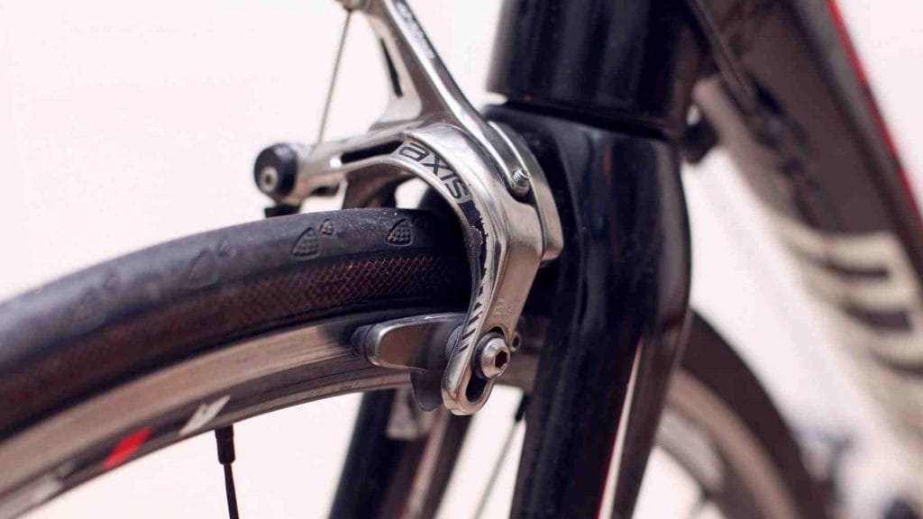 A picture of bike brakes and tire rim.