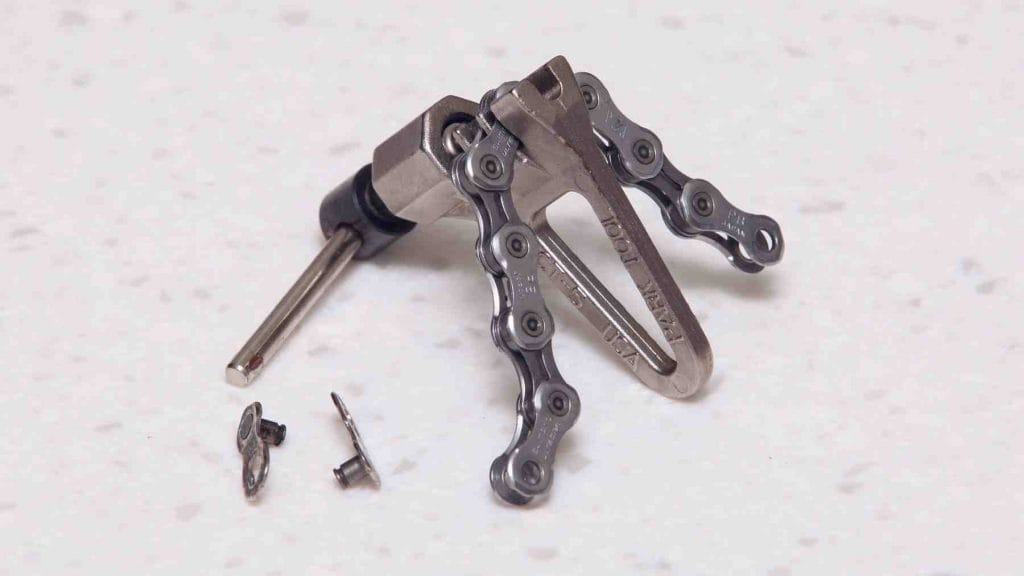 A picture of a chain breaker tool and quick links.