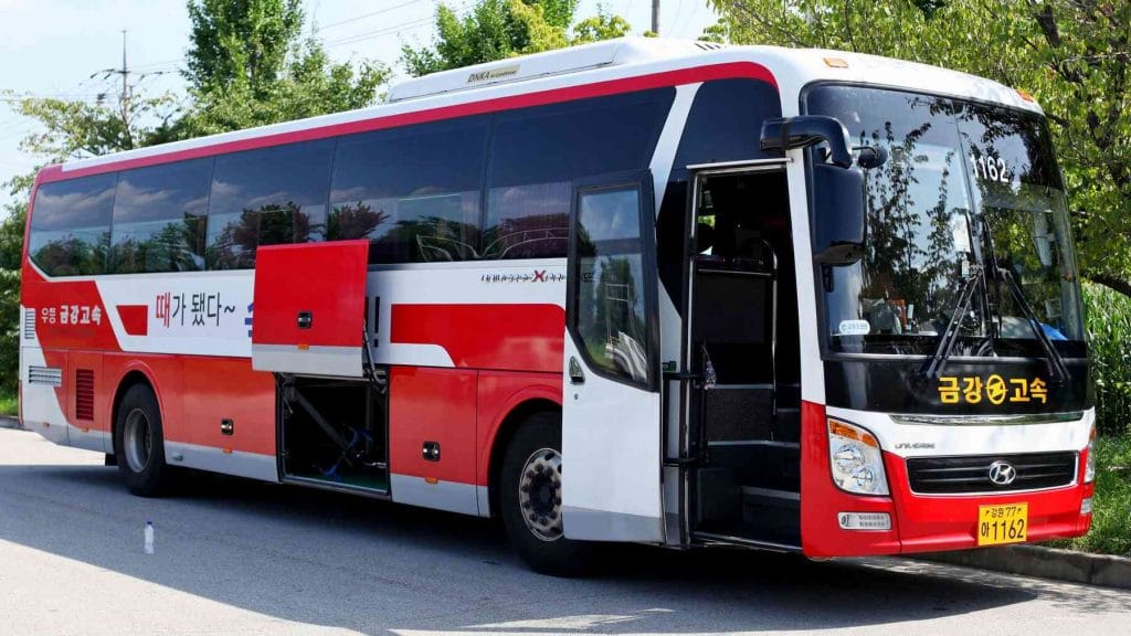 A picture of an intercity bus with the luggage compartment open.