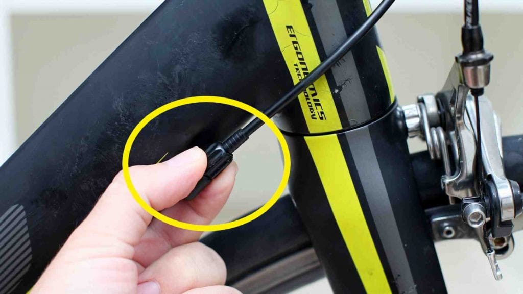 A picture of a bicycle's front derailleur's barrel adjuster.
