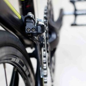 A picture of a front derailleur and its limit screws.