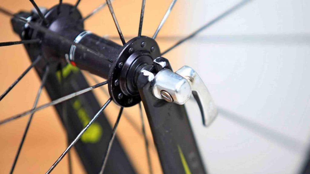 A close-up of a wheel's quick release latch on a bicycle.
