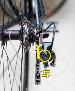 A picture of a bicycle's rear derailleur with its limit screws highlighted.