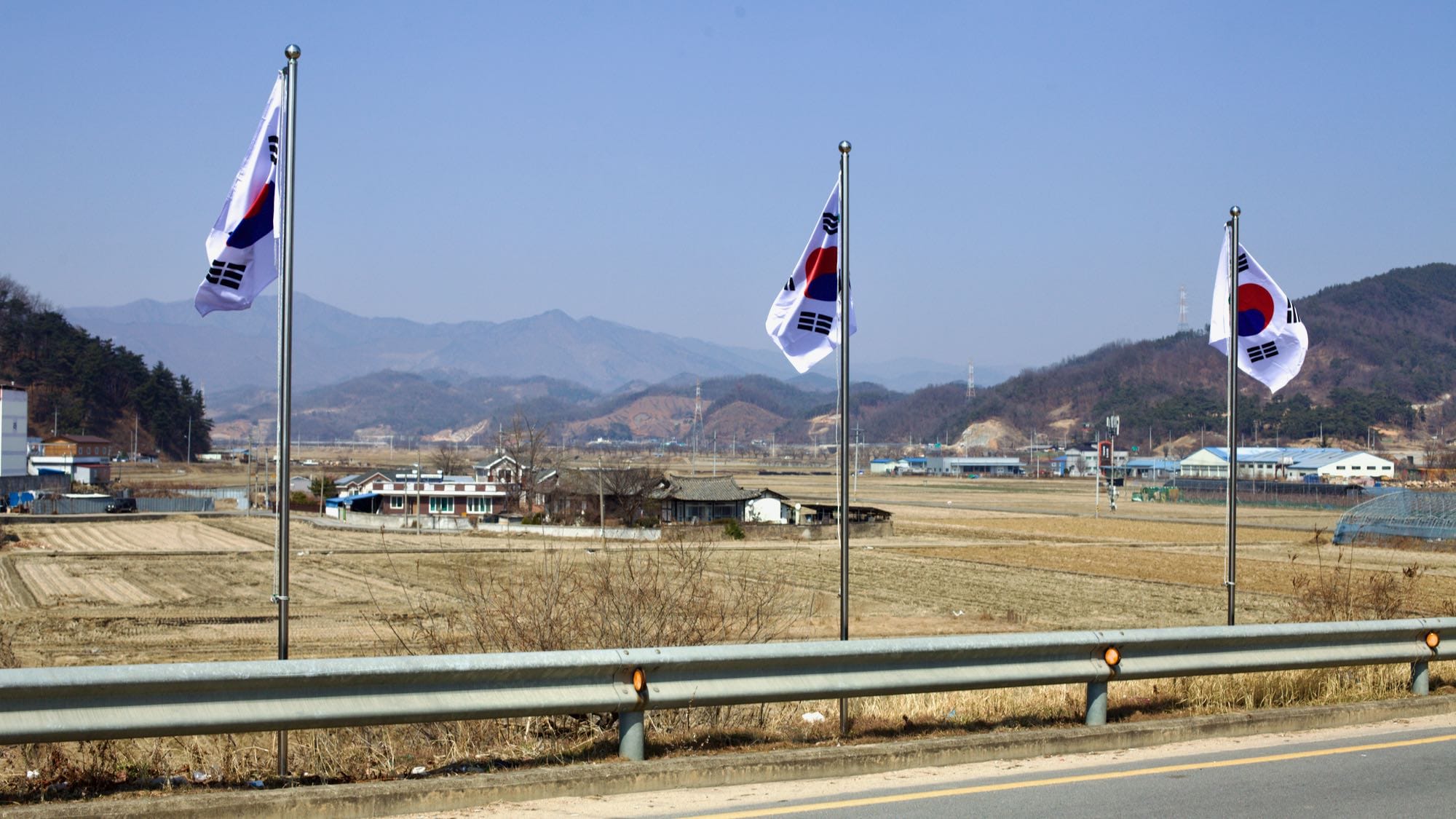 A picture of flags and farm fields near the Jeomchon Neighborhoods on the Saejae Bicycle Path (새재자전거길) in Mungyeong City (문경시), South Korea.