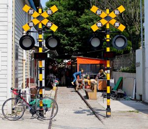 A railroad crossing stands at the entrance of Gunsan Gyeongam Railroad Village.