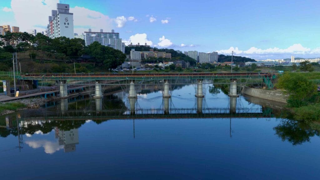 A bridge spans the Yeongsan River, with scaffolding supporting its piers in Gwangju City.