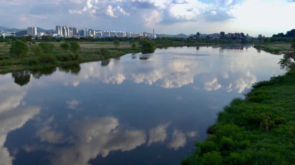 The Yeongsan River mirrors the sky in Gwangju City.