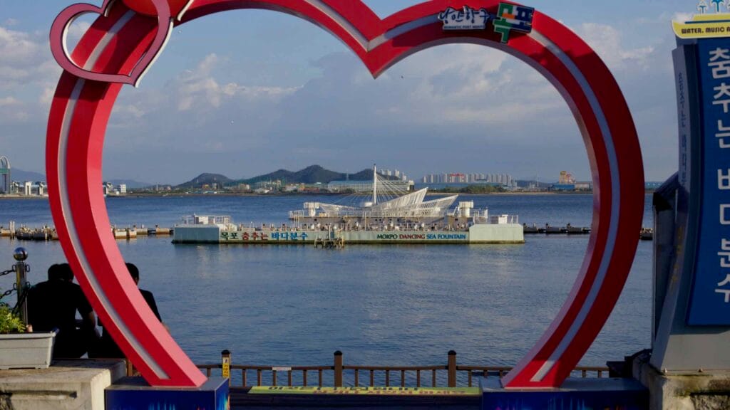 The Mokpo Dancing Sea Fountain is framed through a large red heart-shaped arch at Peace
