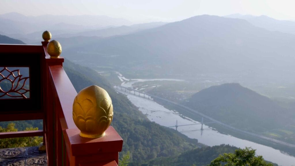A golden lotus finial adorns the red balcony railing of Saseongam Hermitage.