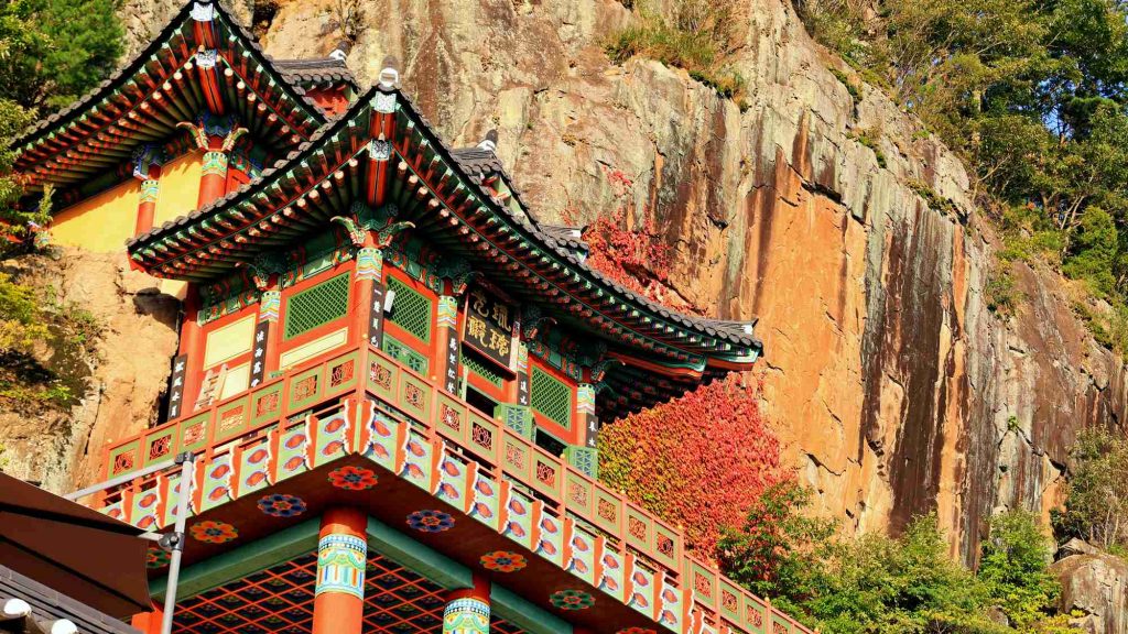 A close-up of the decorated eaves of Yaksa-jeon Hall at Saseongam Hermitage.