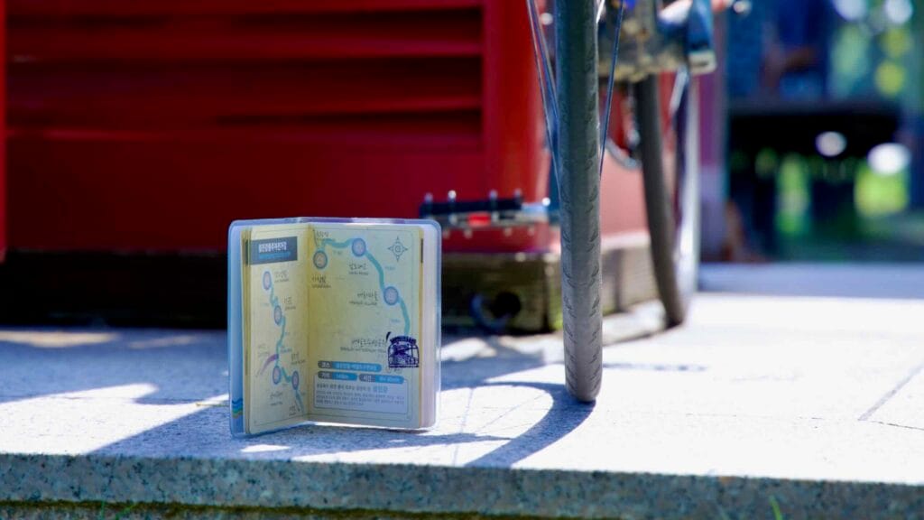 A bike passport sits next to a bicycle tire at the Baealdo Waterfront Park certification center along the Seomjingang Bicycle Path.