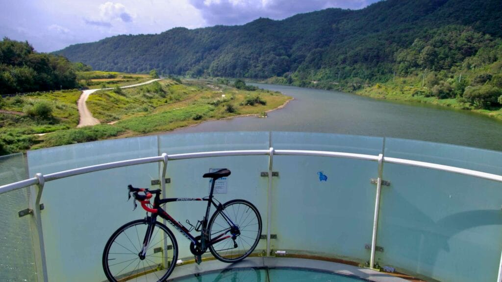A road bike rests on the glass-bottom Skywalk of Hyangga Bridge.