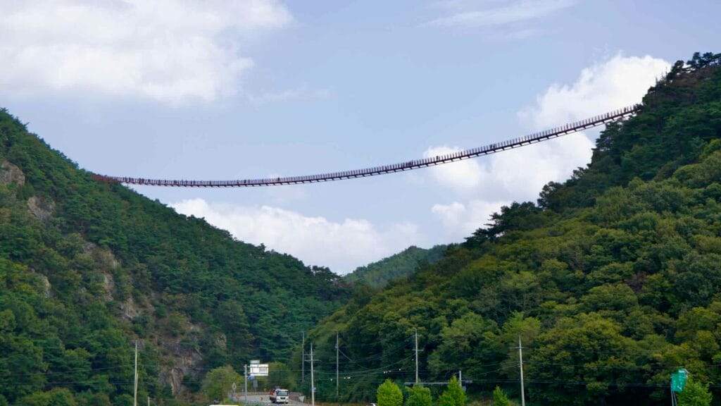 The Chaegye-san Suspension Bridge stretches across a deep mountain valley, connecting the peaks of Chaegye-san.