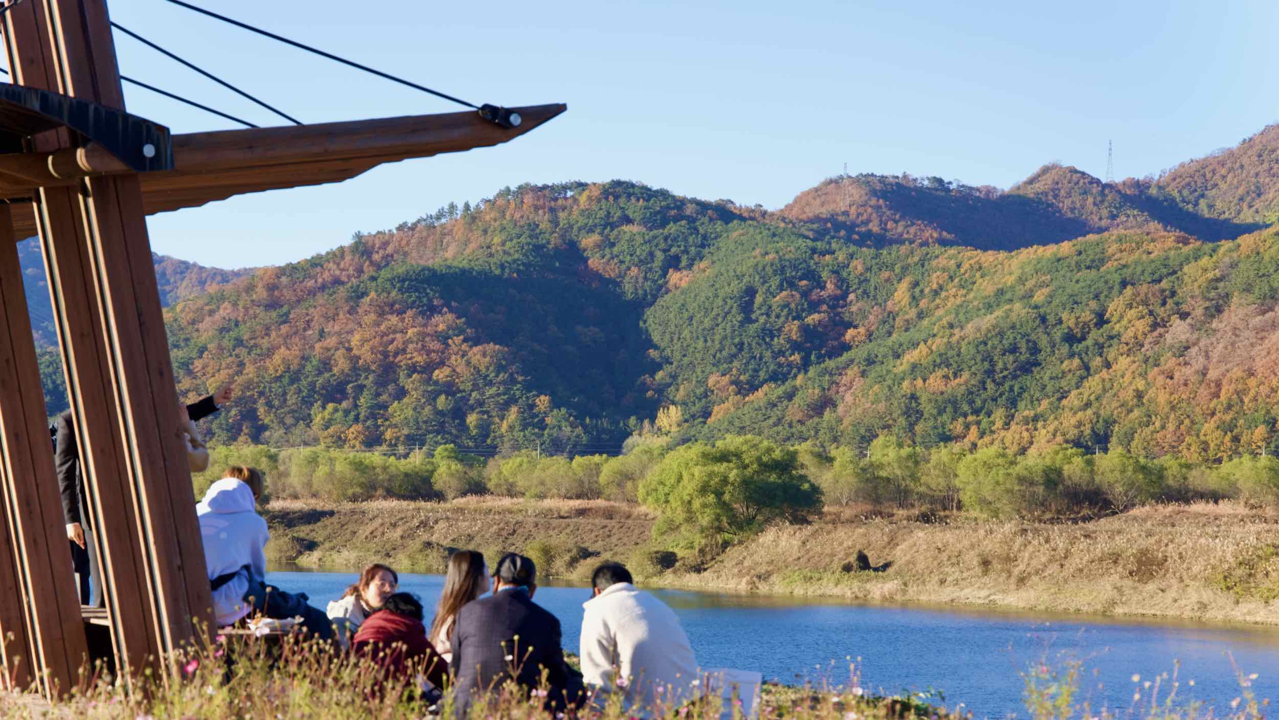 Picknickers sits by the Nakdong River near Dodong Seowon Confucian Academy.