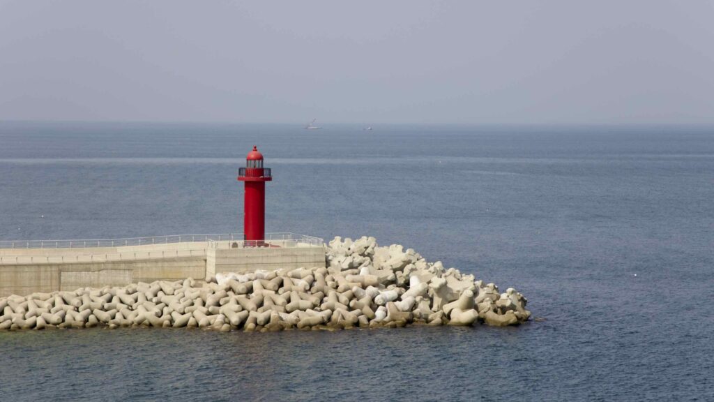 A picture of the red lighthouse sits at the end of Chuksan Port's breakwater in Yeongdeok County, South Korea.