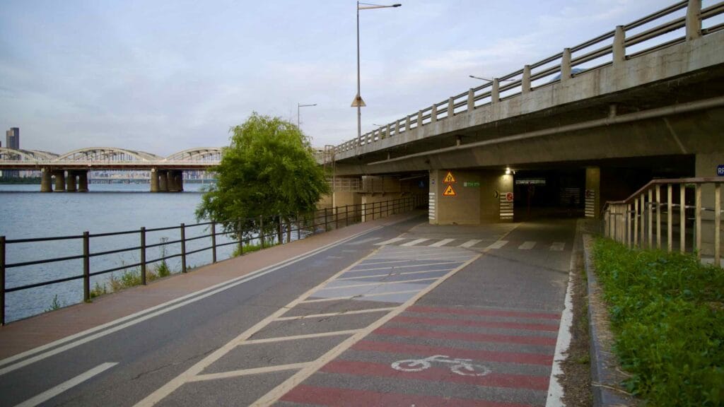 A picture of the bike path under Olympic Boulevard in Banpo Hangang Park (반포한강공원) in Seoul, South Korea.