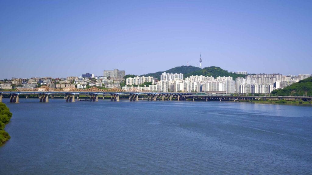 A view of the wide Han River, and Namsan Mountain and Tower between Ttukseom and Jamwon Hangang Parks in Seoul, South Korea.