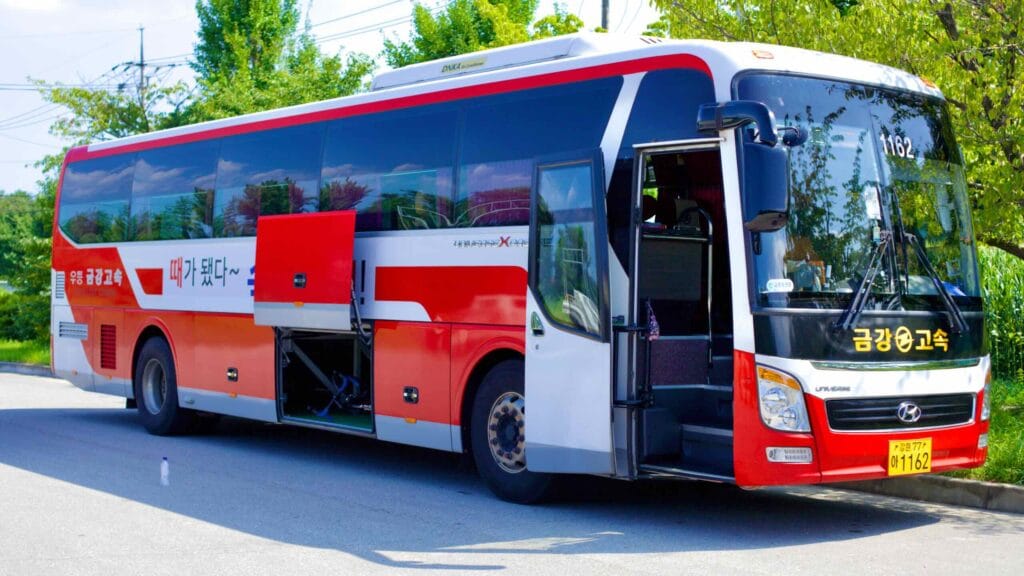 At the Daejin Intercity Bus Terminal, a red and white bus stands ready for its journey to Seoul.