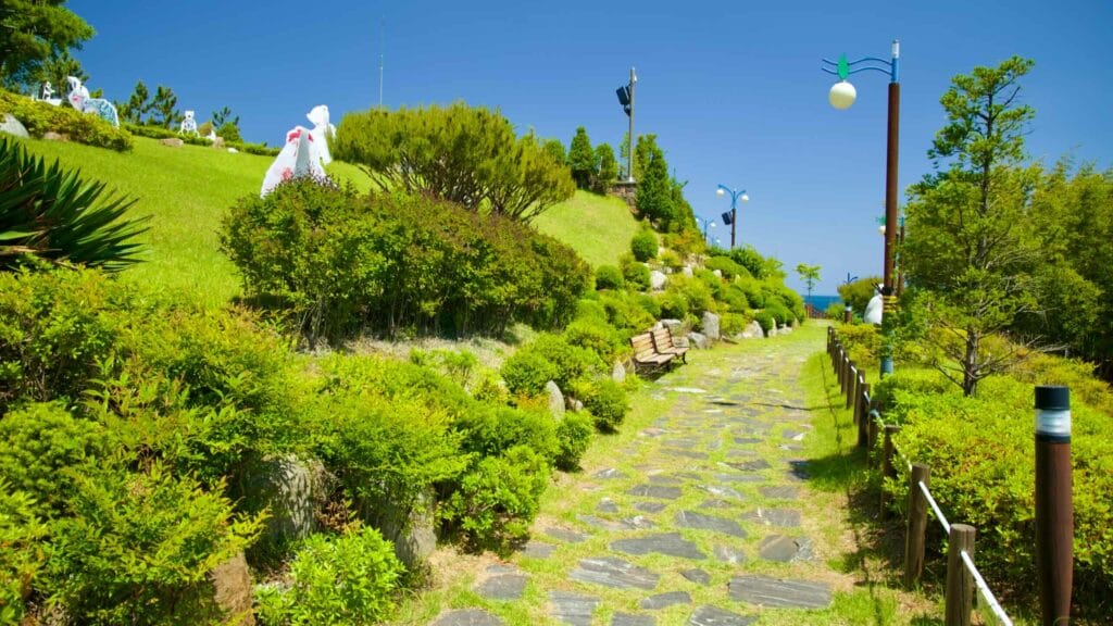 A pathway lined with lush greenery in Isabu Lion Park & Picture Book Land.
