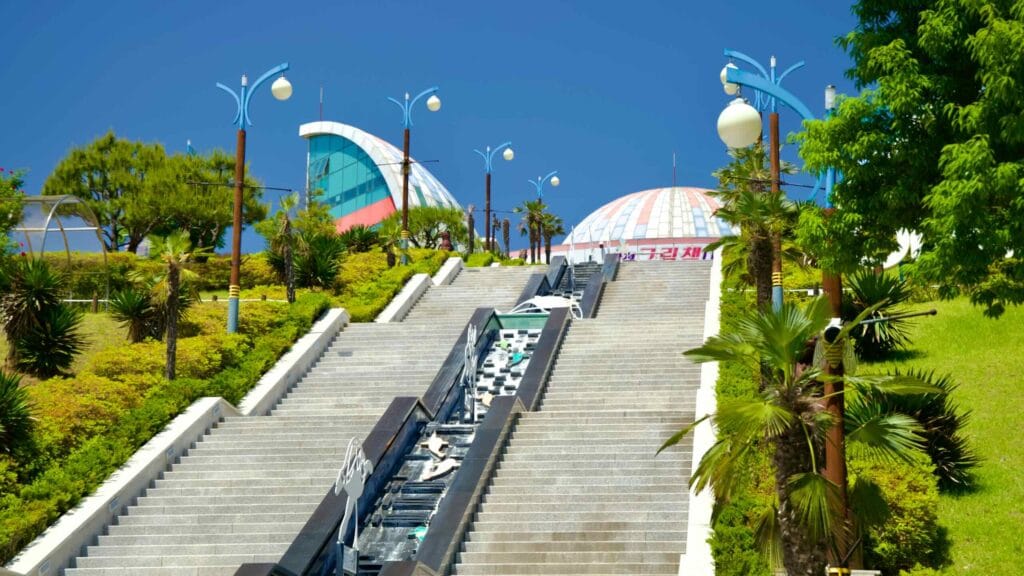 Ascending steps adorned with artistic sculptures lead to the vibrant and colorful Isabu Lion Park and Picture Book Land.