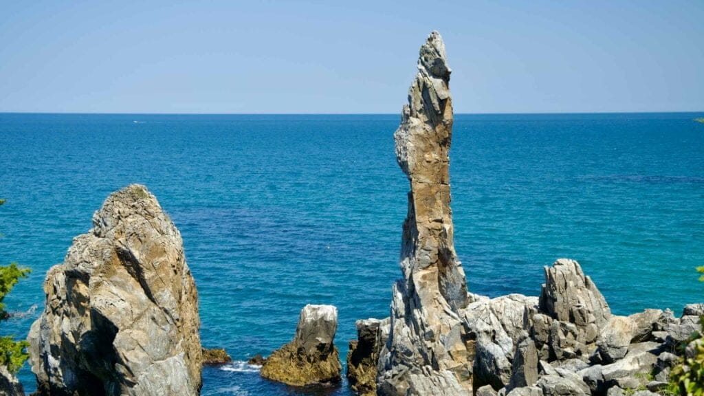 A view of Chuam Candlestick Rock and its neighboring limestone formations, standing tall against the East Sea.