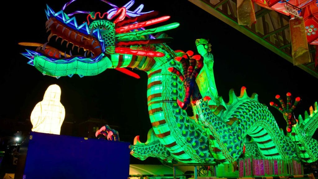 A dragon figure lantern stands at Jeonggwangsa Temple. Atop the dragon, a Buddha figure stands displayed.