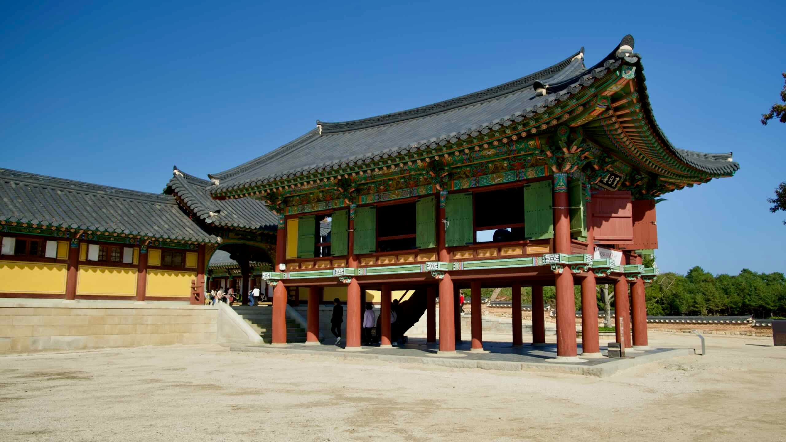 A side view of the Binilru Pavilion at Naksansa Temple, highlighting its elevated structure, vibrant colors, and intricate traditional Korean architectural details.