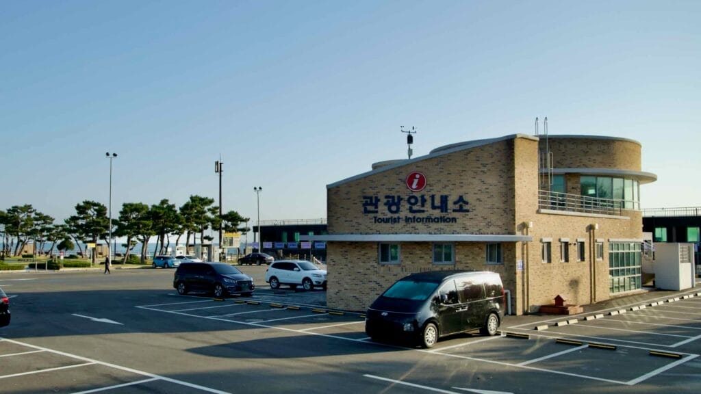 A spacious parking lot beside the tourist information center at Seorak Sunrise Park, offering convenient access and guidance for visitors exploring the scenic coastal area.