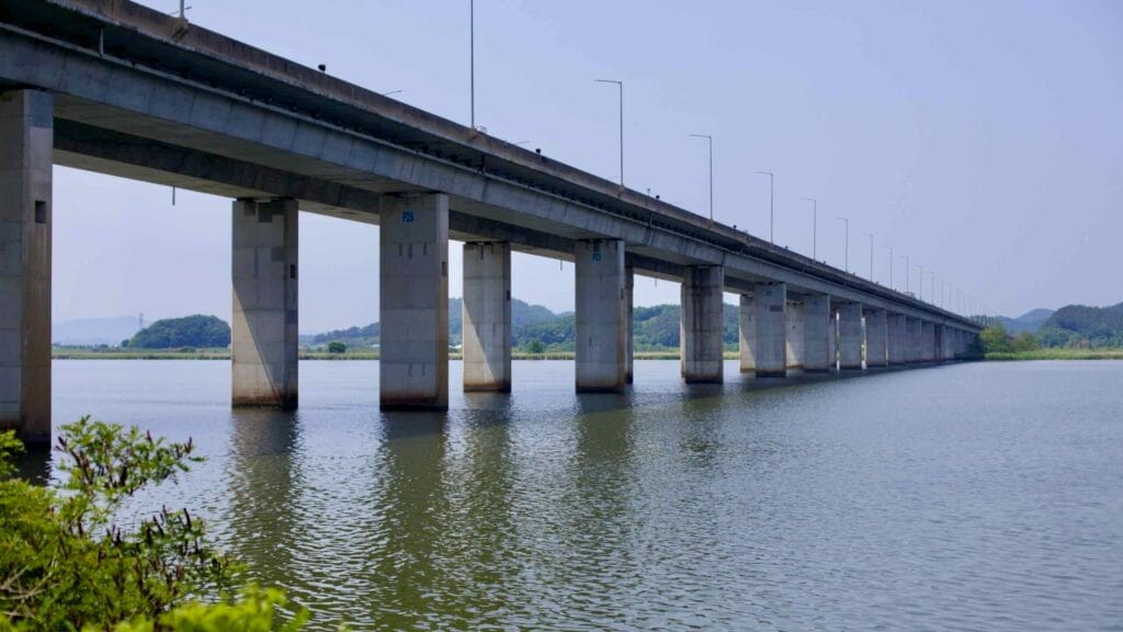 The Geum River Grand Bridge extends across the calm waters, supported by towering pillars.