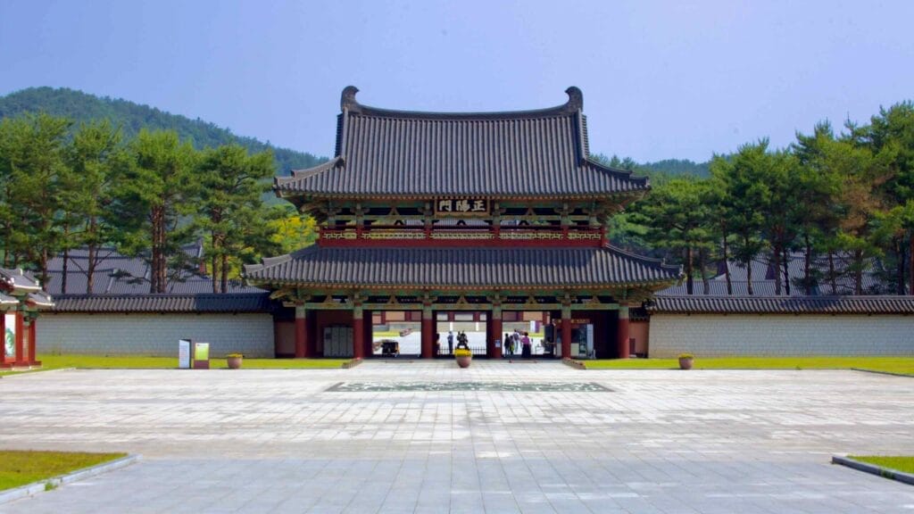 The entrance gate of Baekje Cultural Land stands against a forested backdrop.