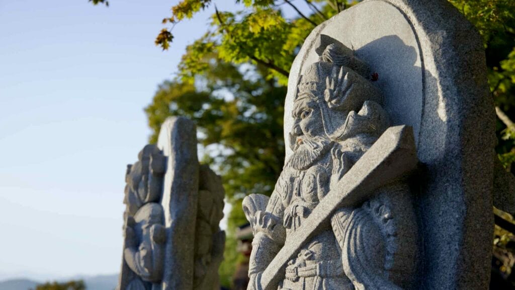 Stone guardian statues stand in a row at Saseongam Hermitage, protectors symbolize spiritual strength.