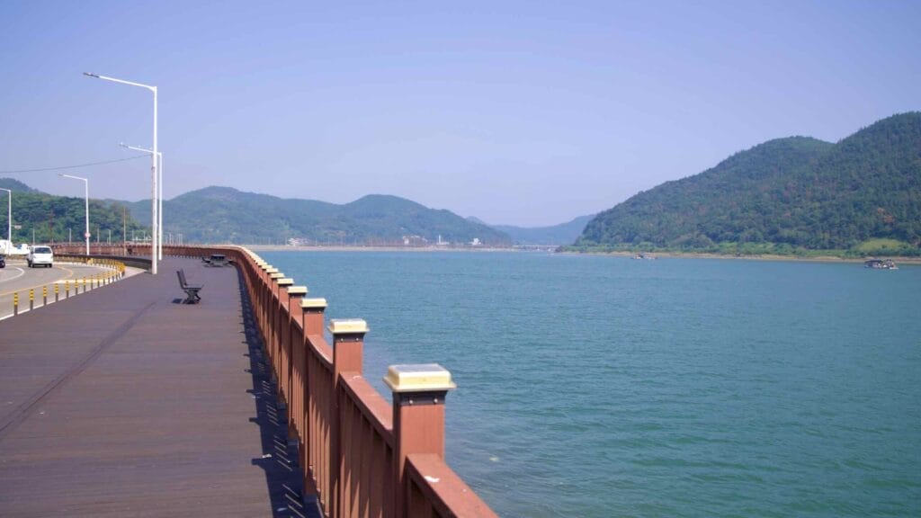 A wooden boardwalk runs alongside the Seomjin River near Mangdeok Port.