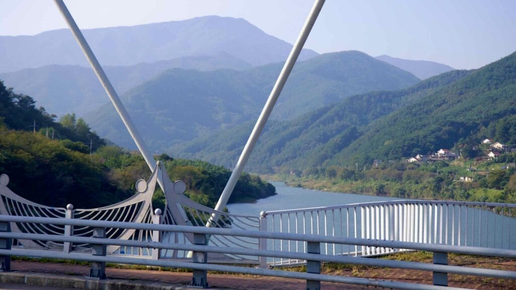 A mountain backdrop frames the Seomjin River, as seen from Namdo Bridge.