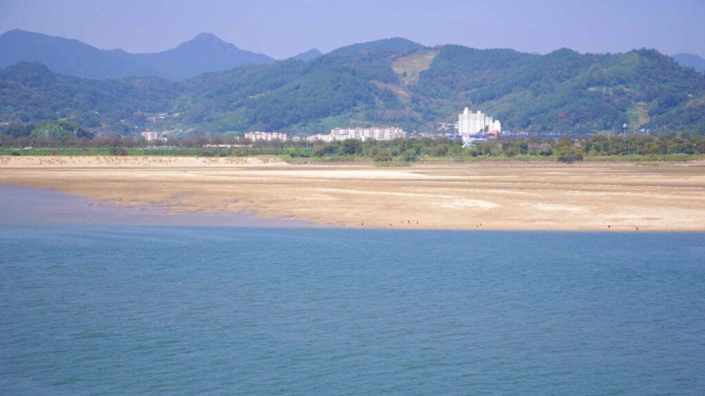 A view of the Seomjin River with exposed sandbanks, reflecting seasonal water levels.