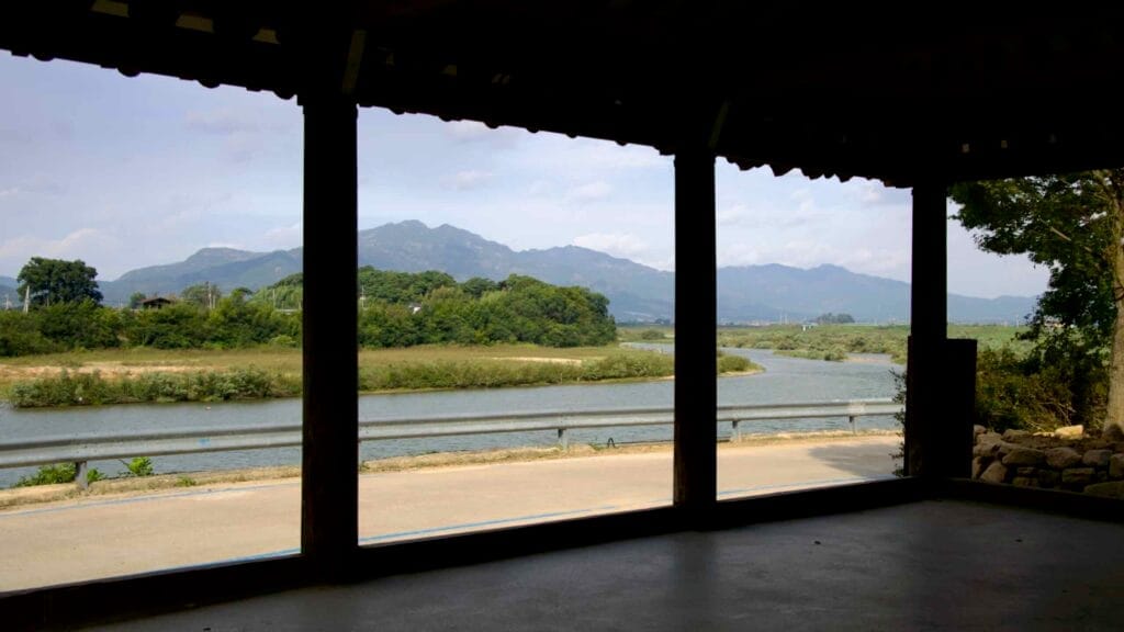 A view of the Seomjin River and distant mountains seen from inside Hwoingtang Pavilion.