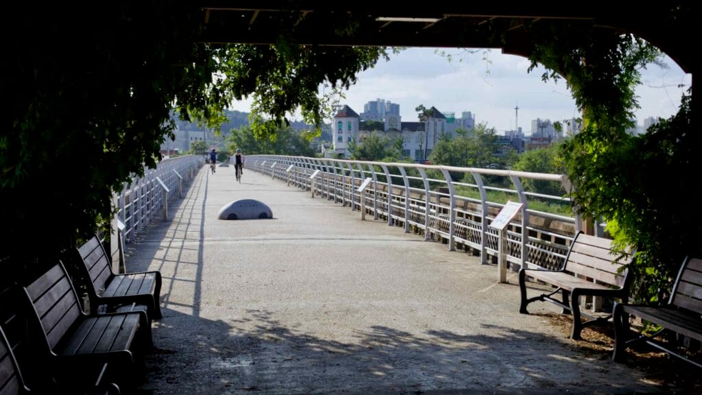 Cyclists ride the Old Sandong Bridge, now a shaded pedestrian and biking path.