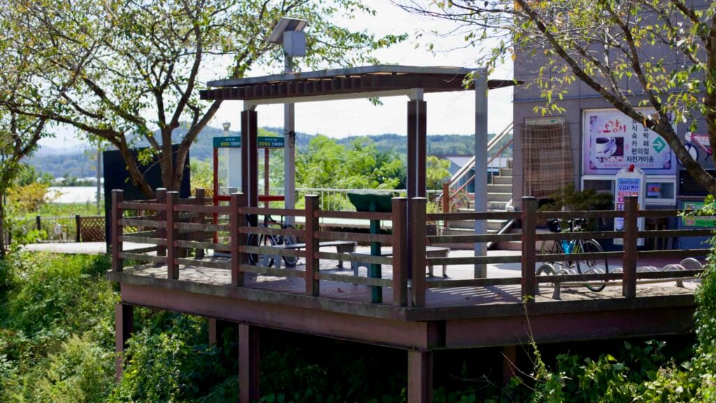 Shaded rest area at Damyang Dam Certification Center provides benches and bike racks.