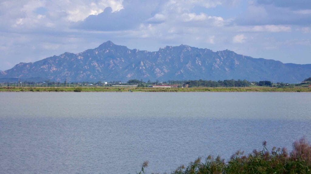 Ha-eunjeoksan Mountain rises in the distance beyond the calm waters of the Yeongsangang River,