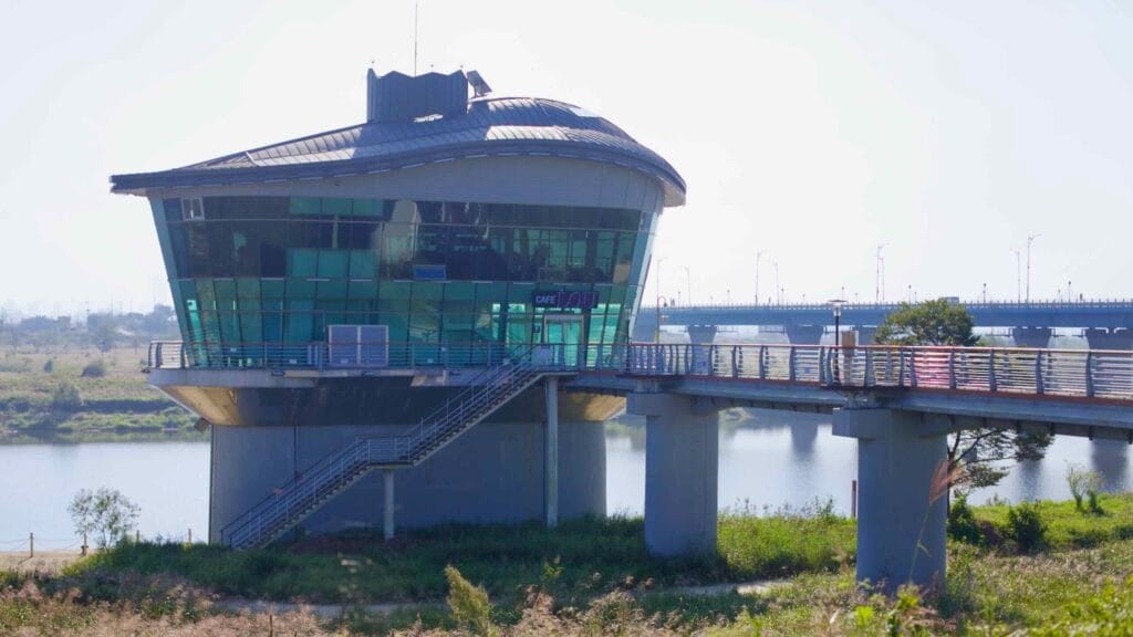 A futuristic glass observatory at Seungchonbo overlooks the Yeongsangang River, connected to