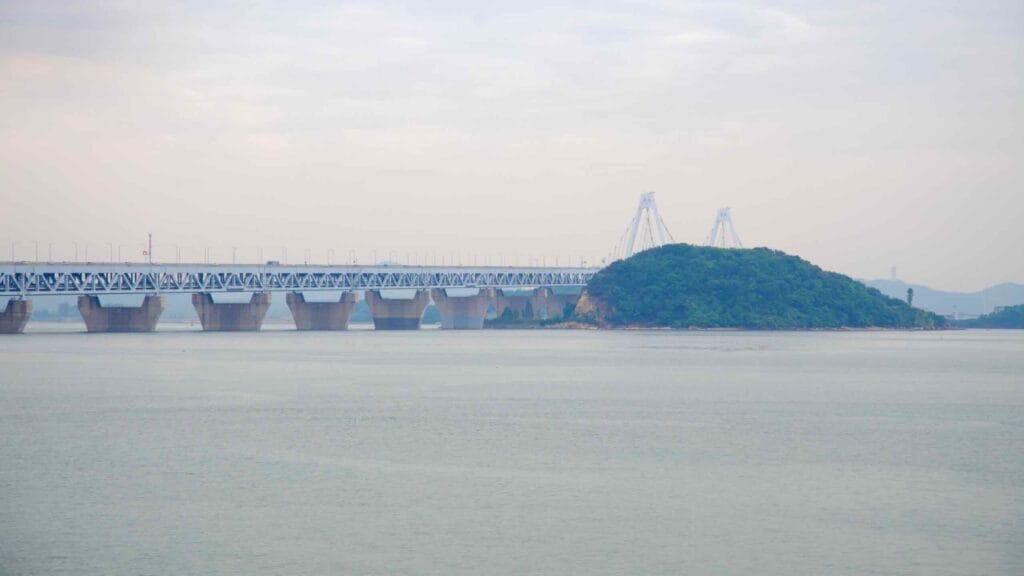 The Yeongjong Bridge stretches across the Yellow Sea, linking the mainland to Yeongjong Island—home to Incheon International Airport—viewed from the Jeongseojin coast near the Ara Waterway.