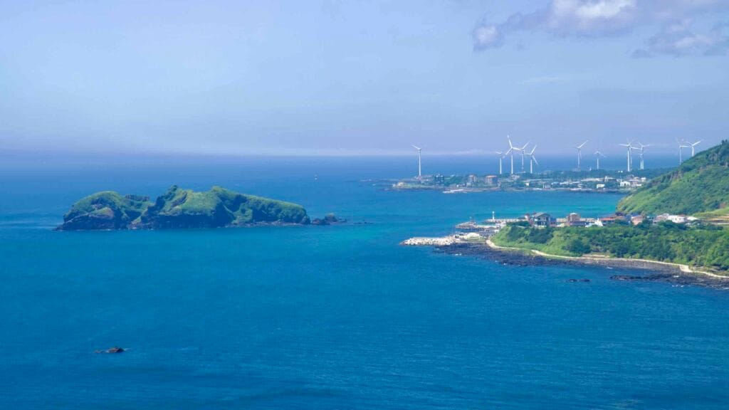 Chagwido and Jeju’s west‑coast wind farm seen from Suwolbong.