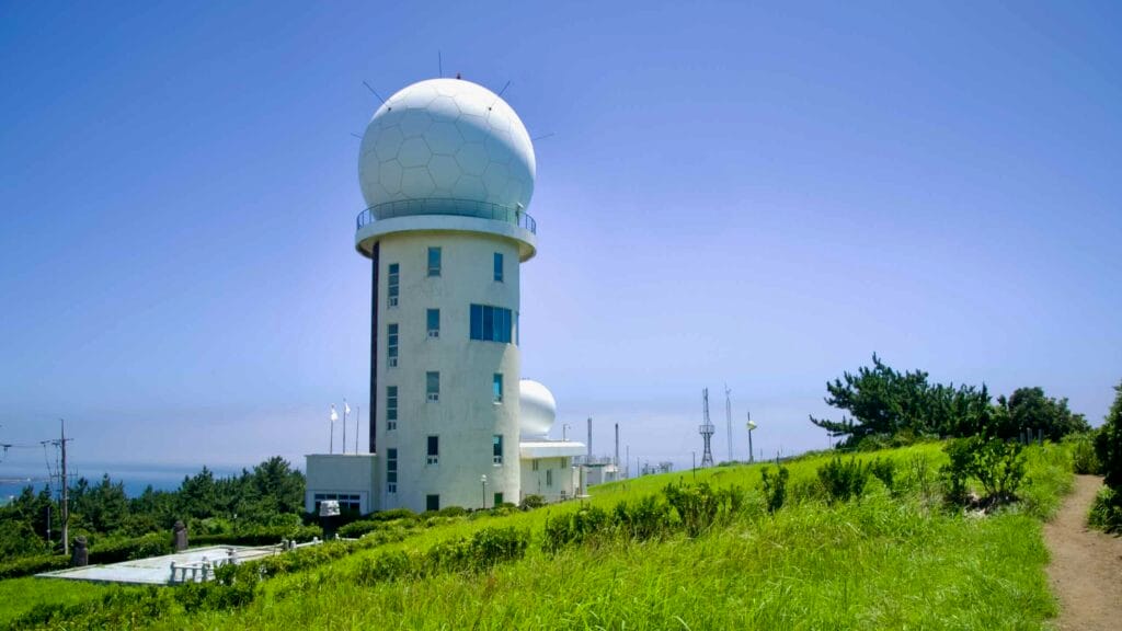 KMA’s Gosan Radar Observatory on Suwolbong’s grassy ridge.