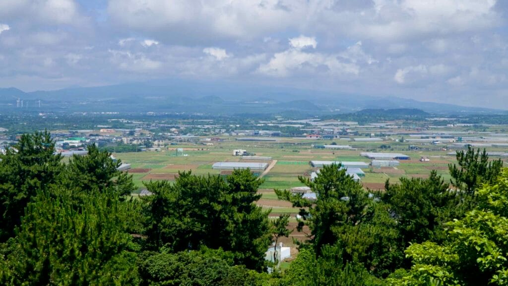 Patchwork fields and low hills seen inland from Suwolbong.