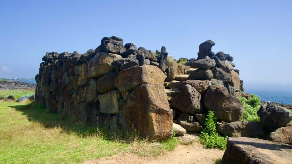 Massive stacked basalt seawall blocks along the Yeongnak shore.